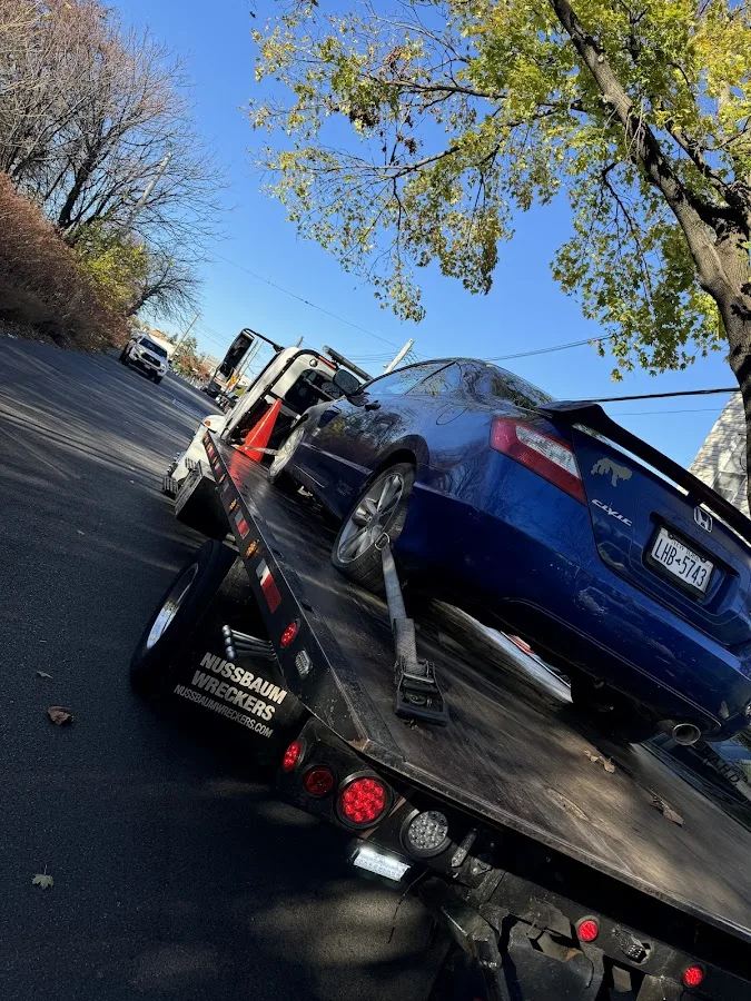 Tow operator coordinating roadside services in Queens